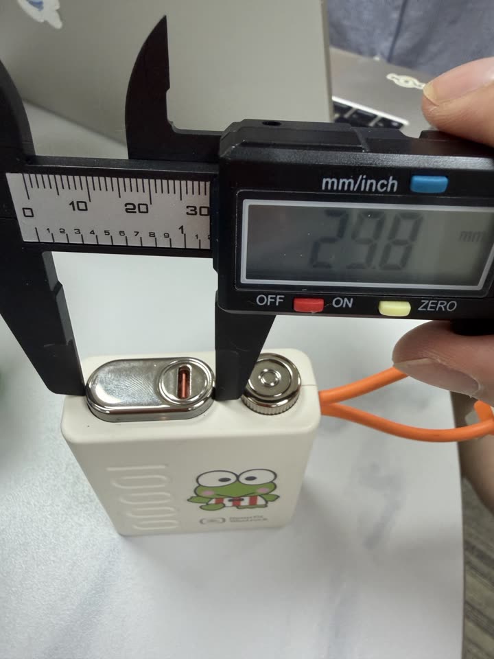 Caliper photo measuring the top port panel at 24.8 millimetres