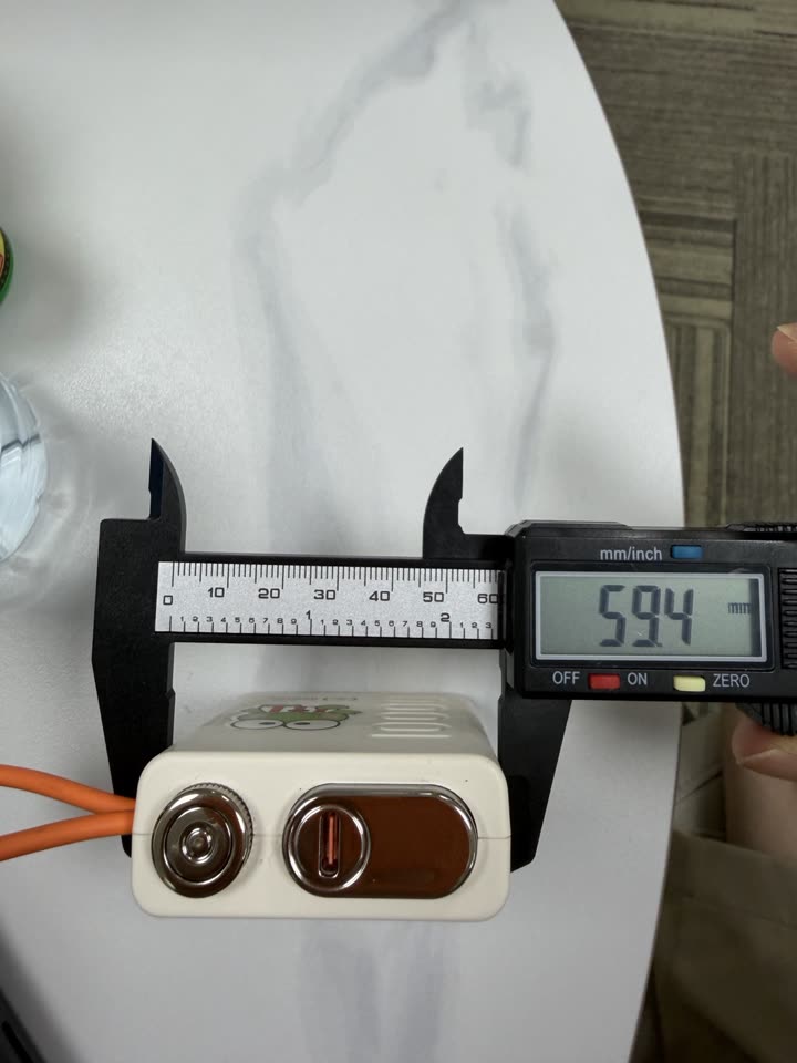 Caliper photo measuring the power bank width at 59.4 millimetres